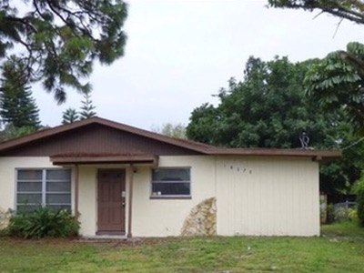The same house before renovation, seen from further back across the front yard.